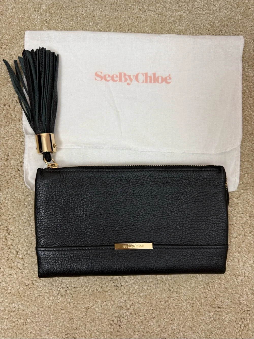 SEE BY CHLOE | black pebbled leather zip wallet clutch with tassel